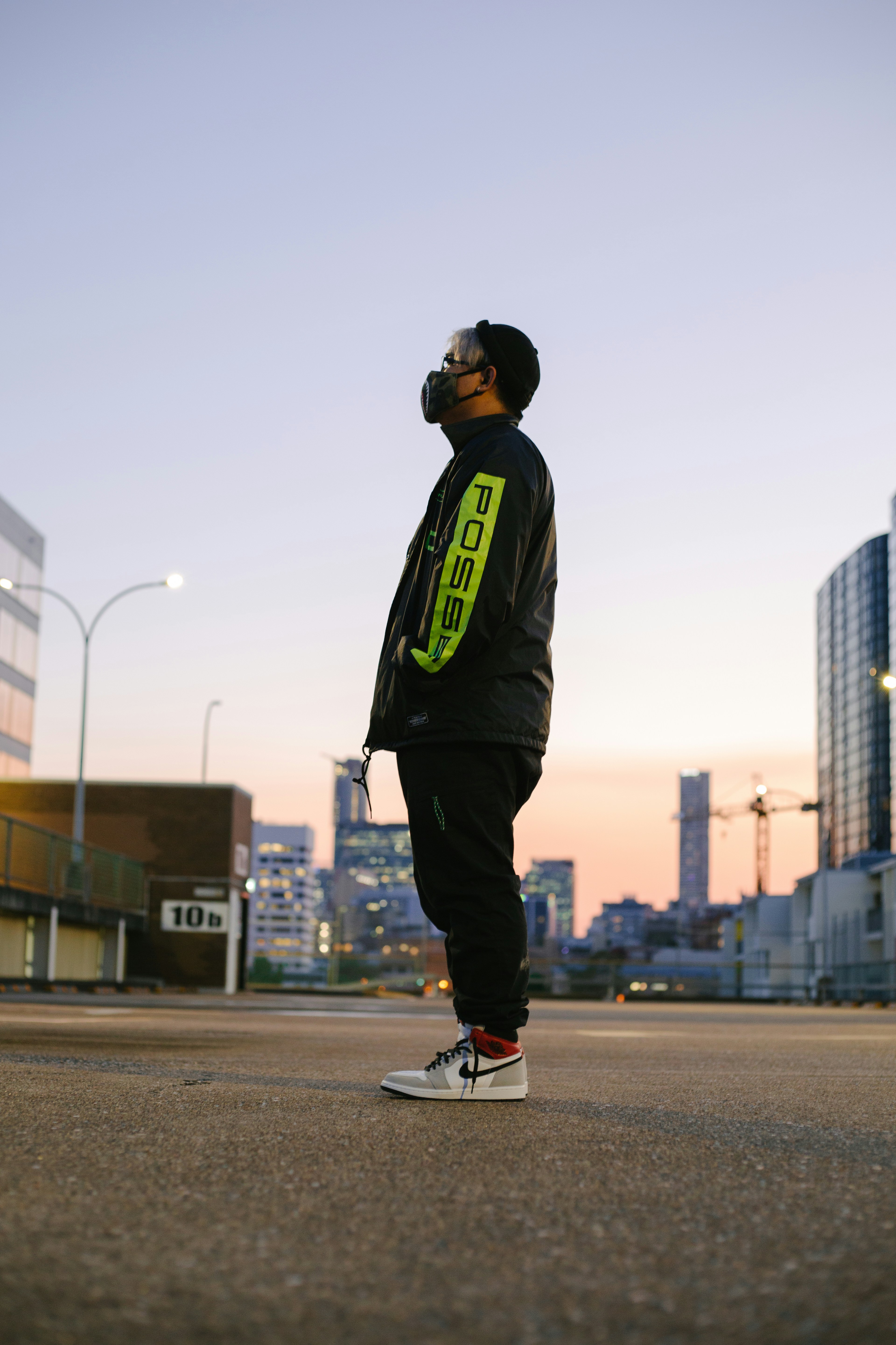Model in windbreaker against posters